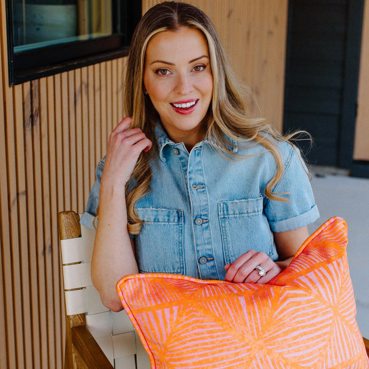 woman sitting in chair holding pillow