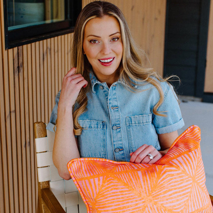 woman sitting in chair holding pillow