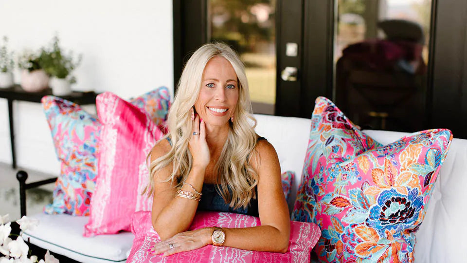 woman sitting on couch with decorative throw pillows