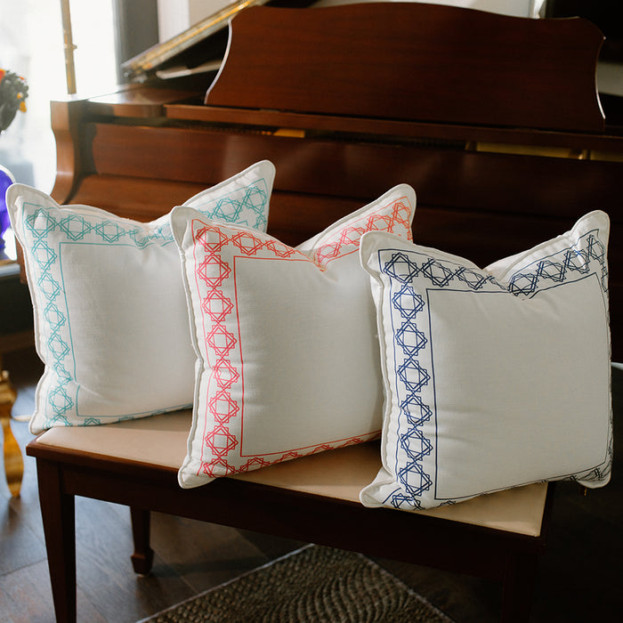 three throw pillows on piano bench